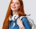 college-life-modern-lifestyle-education-concept-cheerful-good-looking-redhead-female-student-with-foxy-long-hair-wearing-headphones-neck-backpack-smiling-camera